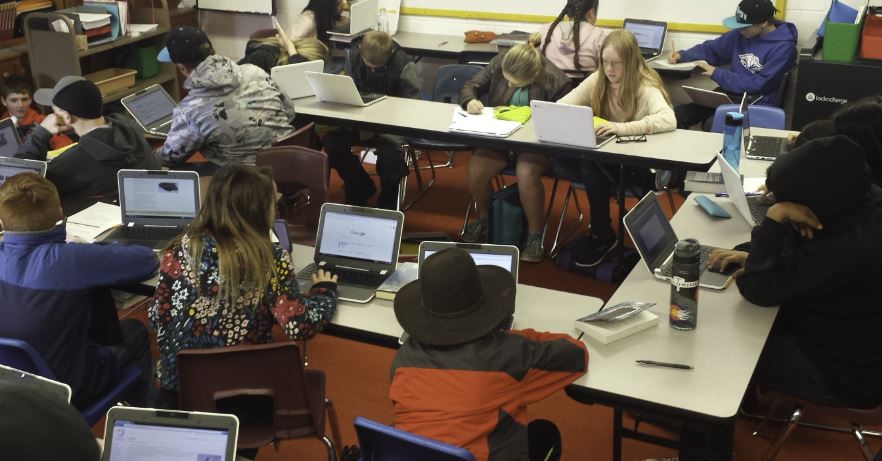 Students looking at chromebooks